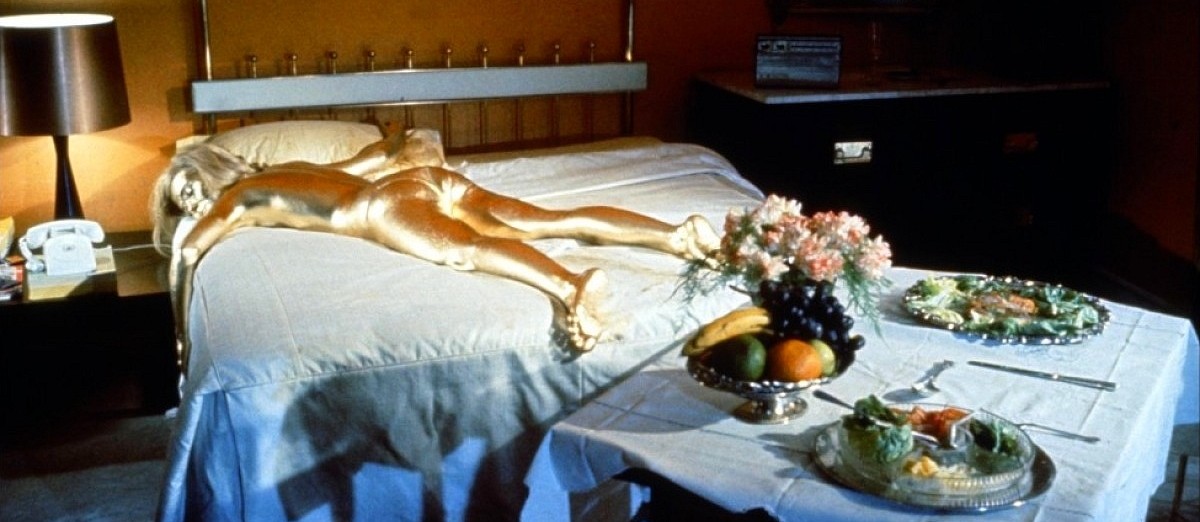 Gold woman laying on bed