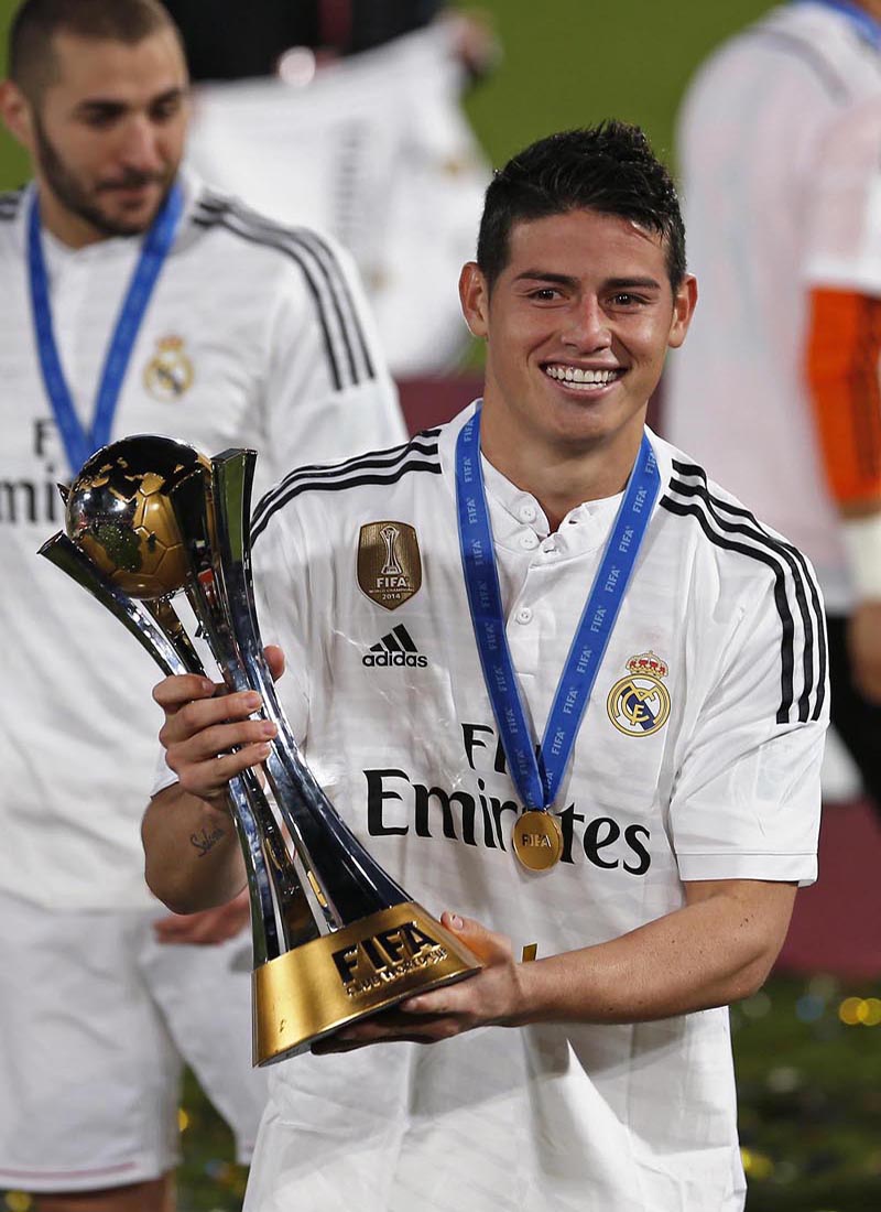 Real Madrid's James Rodriguez holds the trophy after their team won the Club World Cup final soccer match against San Lorenzo at Marrakesh