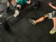 doms-two-men-lying-on-gym-floor-beside-black-barbell-2261483