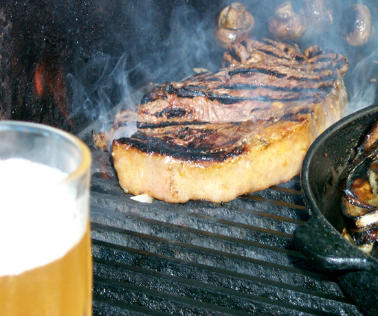 Steak on the BBQ grill with drink- A