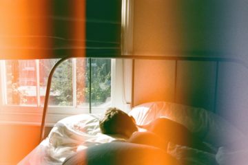 person-sleeping-in-bed-beside-window-1572728