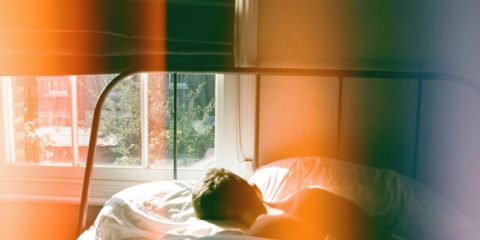 person-sleeping-in-bed-beside-window-1572728