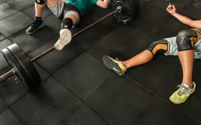 doms-two-men-lying-on-gym-floor-beside-black-barbell-2261483