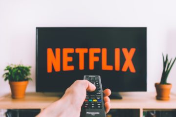 streaming-sports-netflix-closeup-photo-of-person-holding-panasonic-remote-control-in